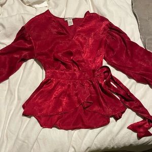 Red, tie- waisted blouse.